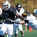 Father Gabriel Richard senior full back Austin Hundley stiff arms a Macomb Lutheran North defender on Saturday. FGR won 24-10. Daniel Brenner I AnnArbor.com